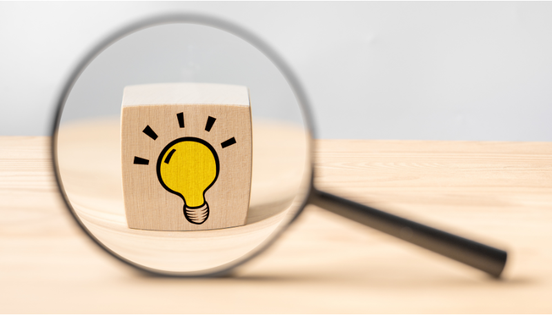 電球の積み木を拡大する虫眼鏡